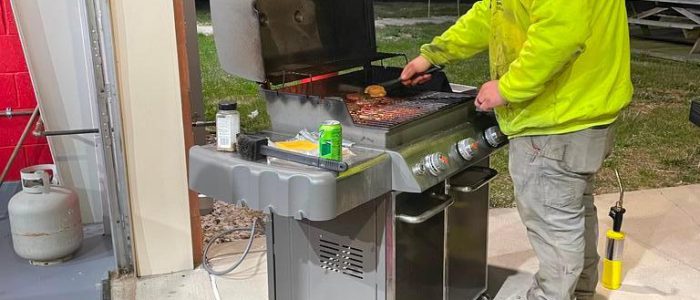 A man grilling at the firehouse