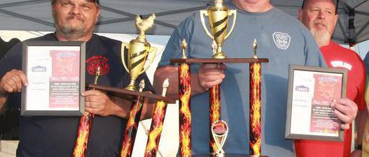 Men holding trophies