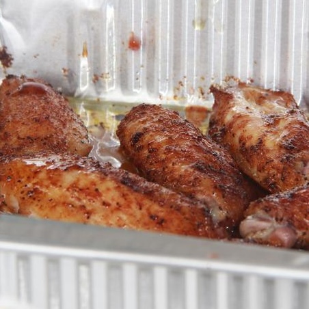 Chicken in sauce in a disposable pan