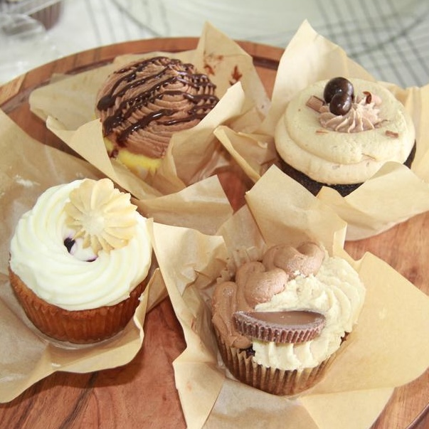 Cupcakes on circular wooden serving tray